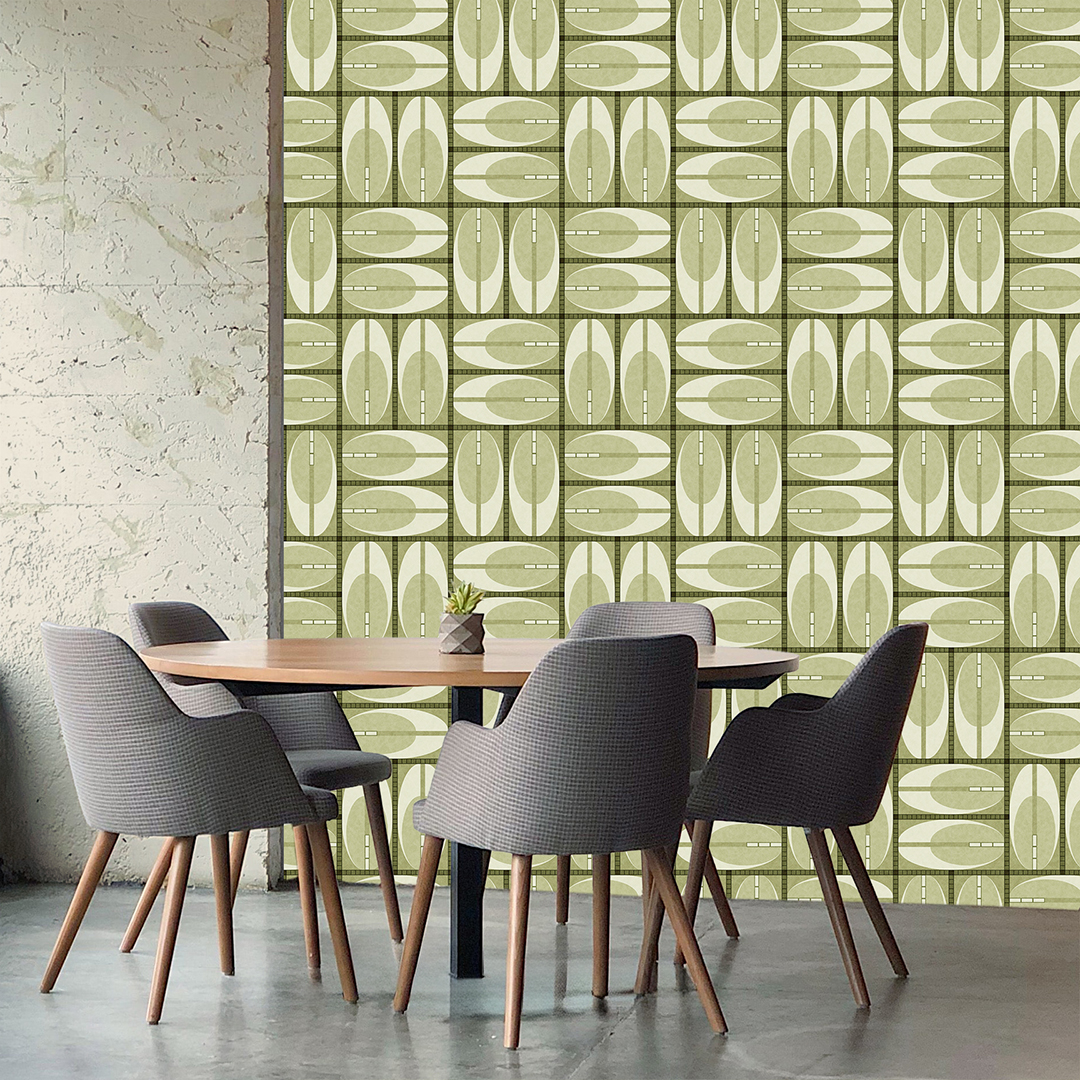 The artwork features a repeating geometric pattern of symmetrical shapes resembling elongated, curved diamonds or petals in various shades of blue and green. Each shape is split vertically with one half filled with a light blue and the other half filled with green or darker blue. The background is a light, almost pastel blue, which provides a soft yet vibrant backdrop. One of the blue shapes near the upper left contains a white starburst element, adding a focal point of brightness to the composition. The overall design conveys a modern, mid-century aesthetic with clean lines and harmonious color contrasts.